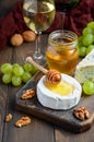 Variety of cheese with grapes, walnuts and wine. Royalty Free Stock Photo