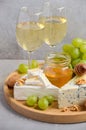 Variety of cheese with grapes, walnuts and wine. Royalty Free Stock Photo