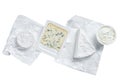 Variety of cheese kinds on kitchen table, brie, Camembert, Gorgonzola and blue creamy cheese. Isolated on white