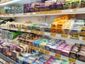 A variety of cheeses and butter are displayed on sales shelves in hypermarkets.