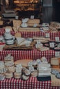 Variety of cheeses at a cheese and charcuterie stand in Borough Market, London, UK