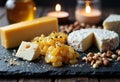 Assorted cheeses with nuts and candles create a cozy, inviting atmosphere for Royalty Free Stock Photo