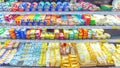 a variety of cheeses in the refrigerated display case In a large supermarket