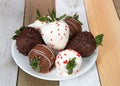 Variety of Chocolate covered strawberries on a plate wood table Royalty Free Stock Photo