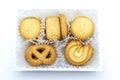 Variety Christmas Danish style butter cookies biscuit placed in the white ruffled paper baking molds in the plastic packaging clos