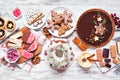 Variety of Christmas holiday desserts and sweets. Above view table scene over white wood.