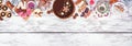 Variety of Christmas holiday desserts and sweets. Above view top border over a white wood banner background. Royalty Free Stock Photo