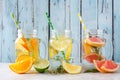 Variety of citrus infused detox water drinks in mason jars against blue wood Royalty Free Stock Photo