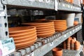 variety of clay flower pots with price tags on the shelves in a garden store