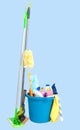 Cleaning supplies in blue bucket on pastel background Royalty Free Stock Photo