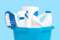 Cleaning supplies in blue bucket on pastel blue background Royalty Free Stock Photo