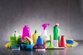 Variety cleaning products on gray background. Royalty Free Stock Photo