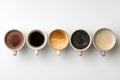 Variety of Coffee Cups Arranged on a White Surface Showcasing Different Types and Colors of Drinks Royalty Free Stock Photo
