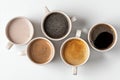 Variety of Coffee Cups Arranged on a White Surface Showcasing Different Types and Colors of Drinks Royalty Free Stock Photo