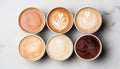 Variety of coffee mugs arranged on a white stone table, captured from an overhead perspective