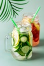 Variety of Cold Summer Drinks in Glass Jars Infused Detox Water with Cucumber Lemon and Strawberry Healthy Drink Green Background Royalty Free Stock Photo