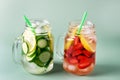 Variety of Cold Summer Drinks in Glass Jars Infused Detox Water with Cucumber Lemon and Strawberry Healthy Drink Green Background Royalty Free Stock Photo