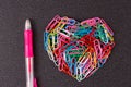 Variety of color paper clips arranged in heart shape Royalty Free Stock Photo