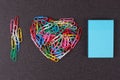 Variety of color paper clips arranged in heart shape Royalty Free Stock Photo