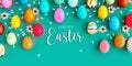 Variety of colored eggs with white flowers decoration and Happy Easter text on turquoise blue background Royalty Free Stock Photo