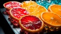 a variety of colored fruit displayed on a plate in front of some glass Royalty Free Stock Photo