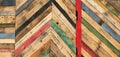 A variety of colored recycled wooden pallets cut and arranged in a herringbone pattern Royalty Free Stock Photo