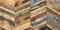 A variety of colored recycled wooden pallets cut and arranged in a herringbone pattern Royalty Free Stock Photo