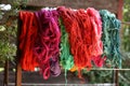 Variety of colored wools hanging outside at daylight invitation to create handmade craft Royalty Free Stock Photo