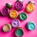 variety of colorful body scrub textures in clear jars on pink surface Royalty Free Stock Photo
