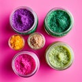 variety of colorful body scrub textures in clear jars on pink surface Royalty Free Stock Photo