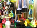 Variety of colorful brooms and brushes, household equipement in shop