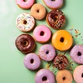 Variety of colorful donuts on green background. Top view. Royalty Free Stock Photo