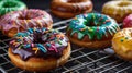 Delicious Assortment of Colorful Donuts with Chocolate Glaze and Rainbow Sprinkles on wire cooling r Royalty Free Stock Photo