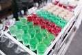 Variety of colorful green red and white beautiful alcohol sweet shooters shots cocktail fresh beverage in small glasses Royalty Free Stock Photo
