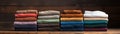 A variety of colorful, plush towels folded neatly and stacked upon a rustic wooden shelf