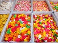 A variety of colorful raw crackers of various flavors and sizes in their respective boxes at a stall