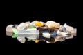 Variety of colorful rough gems, crystals and mineral healing stones, black background