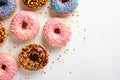 Variety of colorful tasty glazed donuts on a white background