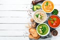 Variety of colorful vegetables cream soups. Concept of healthy eating or vegetarian food. Top view.