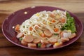 Spaghetti for children in plate on wooden table.