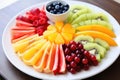 a variety of colourful, cut fruits on a white plate Royalty Free Stock Photo