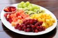 a variety of colourful, cut fruits on a white plate Royalty Free Stock Photo