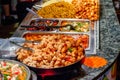 Variety of cooked Chinese food on display for takeaway at Camden market in London Royalty Free Stock Photo