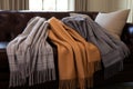 variety of cozy cashmere throws on a couch