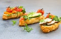 Variety of croissant sandwiches with grilled pepper, tomatoes, smoked salmon, turkey, avocado and arugula served with micro green Royalty Free Stock Photo