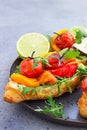 Variety of croissant sandwiches with grilled pepper, tomatoes, smoked salmon, turkey, avocado and arugula served with micro green Royalty Free Stock Photo