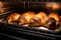 A variety of croissants baking inside an oven, ready to be beautifully golden and irresistibly flaky, fresh croissants in rack in Royalty Free Stock Photo