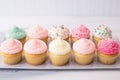 variety of cupcakes decorated with different colored sprinkles