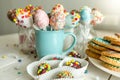 Variety of decorated candies, cake pops and cookies on white desk