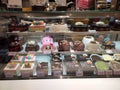 A variety of decorative cakes are placed on a glass chiller rack to make it easier for customers to choose.